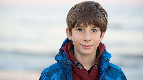 A young male smiling at the camera