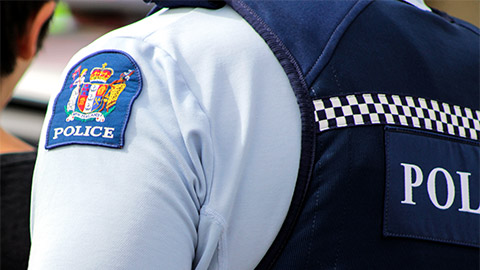 The back of a New Zealand Police Officer as they walk away from the camera