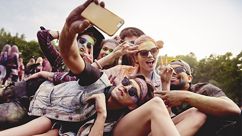 Young group of friend posing for a selfie taken on a mobile phone