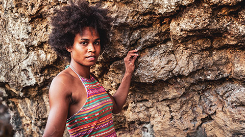 A young female Pasika person standing in an outdoor location