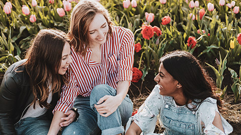 A group of young friends relaxing and laughing outdoors