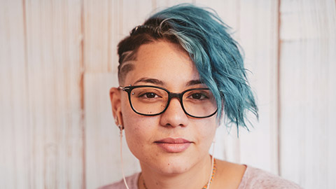 A tight shot of a female with short dyed hair