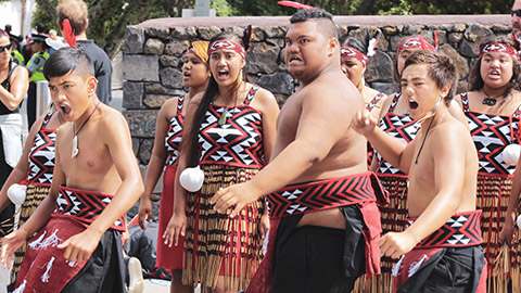 A group of young Maori performing a haka