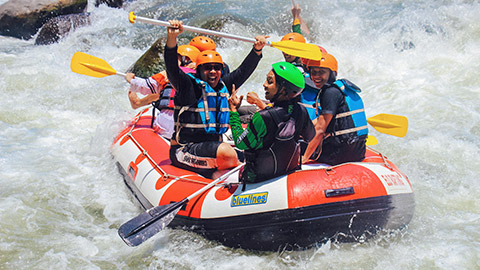 A group of youths enjoying white water rafting