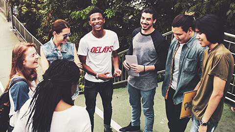 A group of youth talking with a mentor