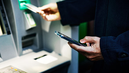 A person operating an ATM