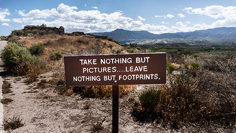 A sign in  a toursit site about resposibility as tourists