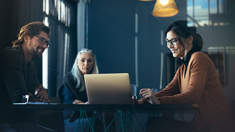 Three colleagues talking in an office