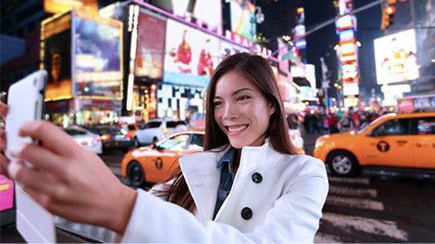 Woman taking selfie on Manhattan street