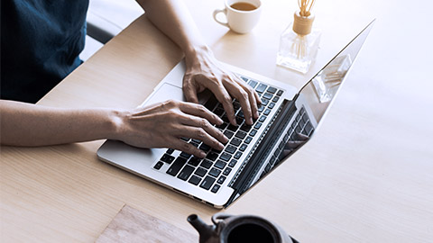 Woman's hand on computer