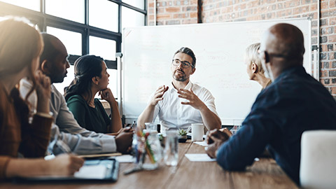 Man, manager and meeting or presentation in boardroom with coworkers