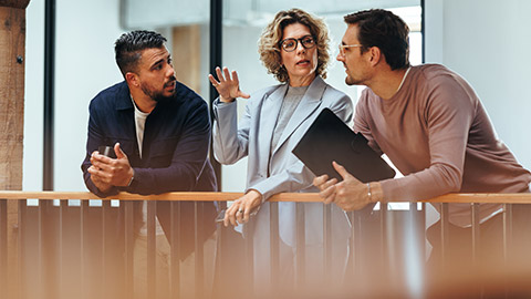 A group of coworkers talking in an office