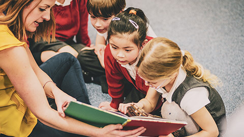 A teacher interacting with a group of students