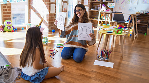 teacher and toddler doing artwork