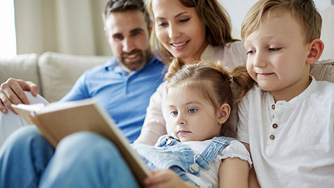 a photo of a family reading a book