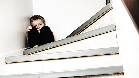 a neglected child on a stair case