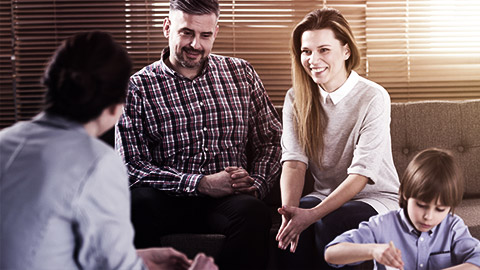 a teacher and parents discussing about their child