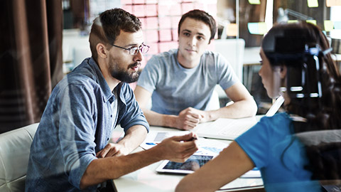 three people meeting together discussing ethics