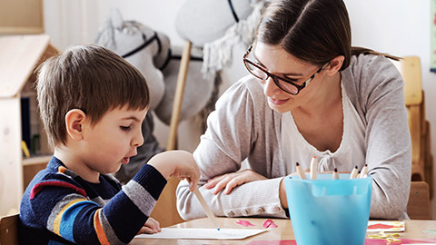 a teacher observing a child while their working on an activity