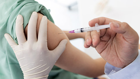 shoulder of a child with vaccination