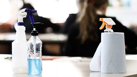 A cleaning materials on top of a classroom table