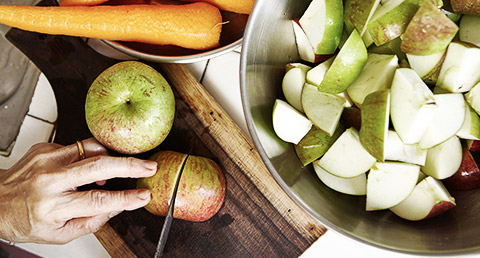 A person cutting fruits