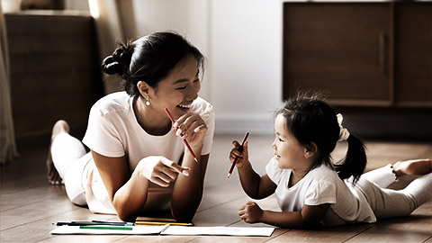 A toddler being taught by a teacher or mother