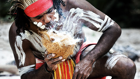 An aborigine starting a fire