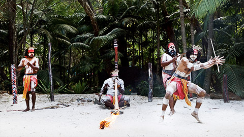 Group of Australian Aboriginal people dancing and play music of  Indigenous Australian dance during a culture show in the tropical far north of Queensland, Australia