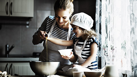 A mother and a toddler making home cooked food