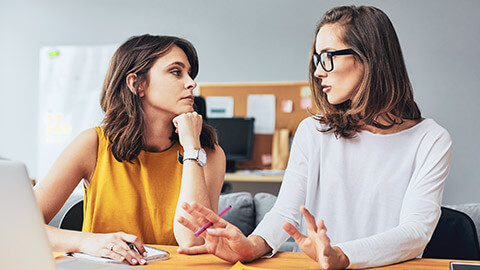 2 workers discussing a case in an office environment