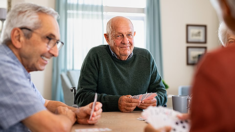 A group of senior citizens playing cards