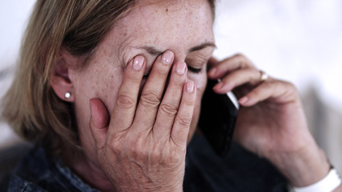 Sad matured woman talking on the phone