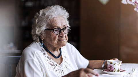 Old woman with cup of tea