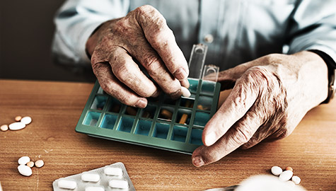 A person looking at medicine schedule