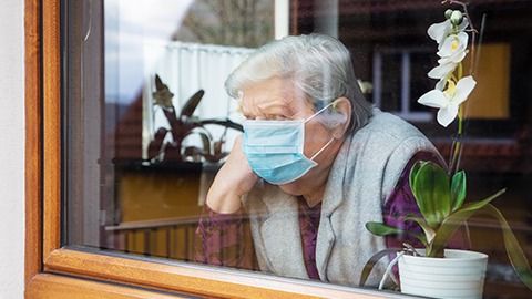 a lonely senior looking outside