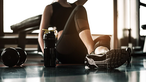 A gym goer drinking after a workout