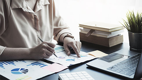 A person analysing documents for compliance