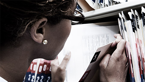 A person inspecting confidential files