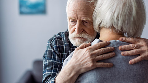 senior woman hugged by husband