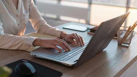 Woman typing on laptop