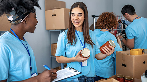 Diverse people packing food