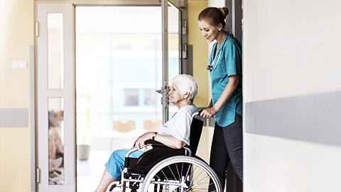 A carer professionally handling a patient