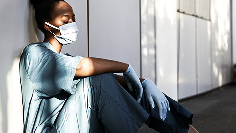 A carer in scrubs getting a short nap on the aisle to calm stresses