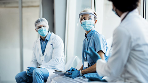 A group of medicalprofessionals and carer debriefing after an emergency