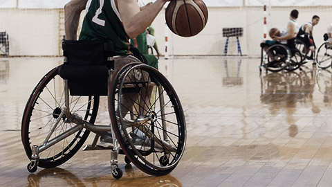 A wheelchair basketball player dribbling