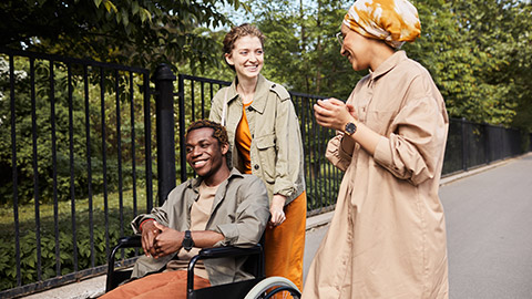 Young multi-ethnic friends talking during stroll