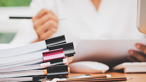 Close view of female at desk doing paperwork