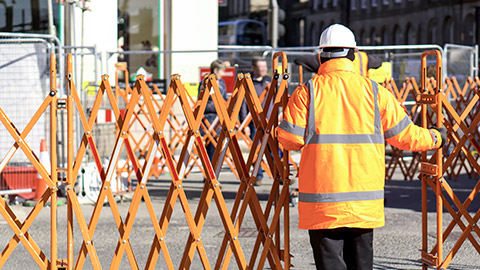 Image-Isolation-Photo of Construction Worker Placing Safety Barrier