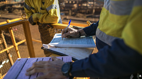 Construction supervisor reviewing organisational policies